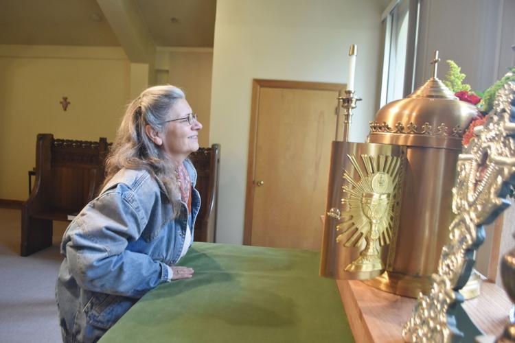 Carol Curin inspects historic relics inside the old St. Francis Friary in Burlington