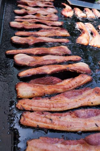 House-cured double smoked maple bourbon bacon sizzles on the grill at second annual Bacon Fest