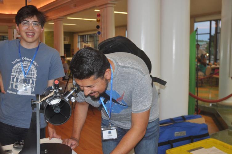Gabriel Ochoa of Villa Lake, Illinois looks through a telescope during the star party, while