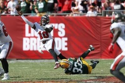 Green Bay Packers safety Evan Williams tries to tackle Tampa Bay Buccaneers quarterback Jalon Daniels.