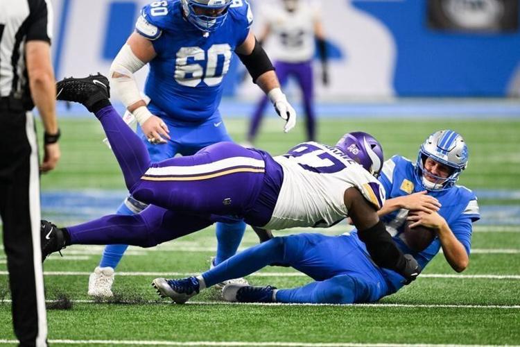 Nov 2, 2025; Detroit, Michigan, USA; Detroit Lions quarterback Jared Goff (16) is brought down by Minnesota Vikings defensive lineman Javon Hargrave (97) in the third quarter at Ford Field. Mandatory Credit: Lon Horwedel-Imagn Images