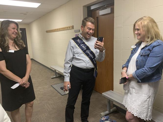 Mr. Lake Geneva Skip Harless takes a phone call from Geneva Lakes Family YMCA Associate Director Sherri Baker
