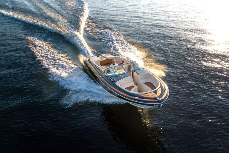 Gage Marine Corp. President and CEO Bill Gage, Jr. drives a boat on Geneva Lake