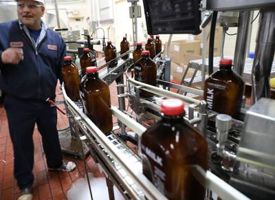 Arnulfo Chavez watches milk on a bottling line at Oberweis Dairy in North Aurora, March 1, 2017.
