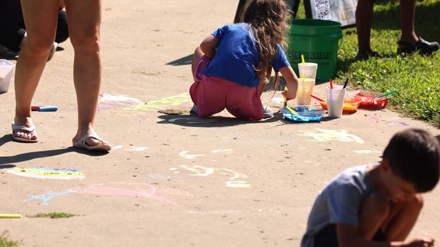 Kids chalk the sidewalk at Gone Readin' Reel-In Party