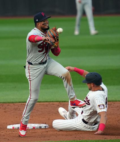 Philadelphia Phillies second baseman Luis Arraez (4) throws to first for a double play as Minnesota Twins left fielder Trevor