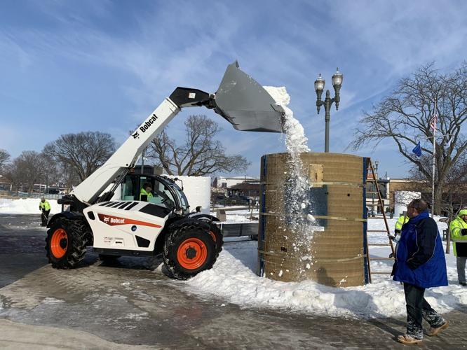 A large cylinder being filled with snow
