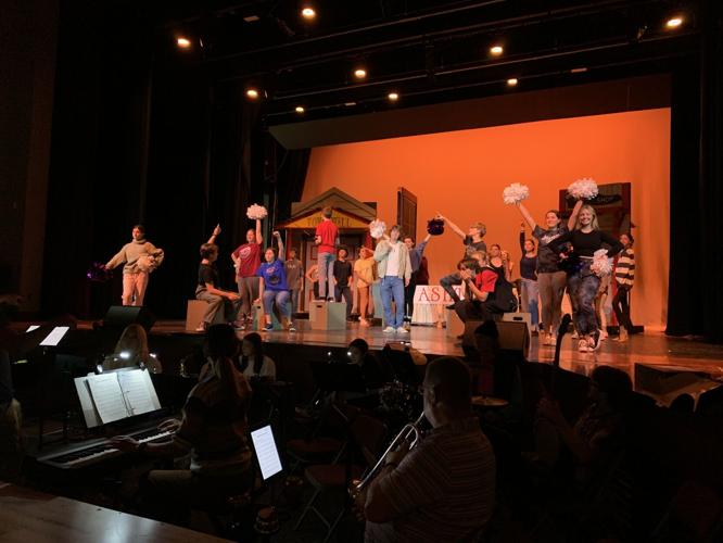 The cast of "Big Fish: The Musical" end a scene during a rehearsal session