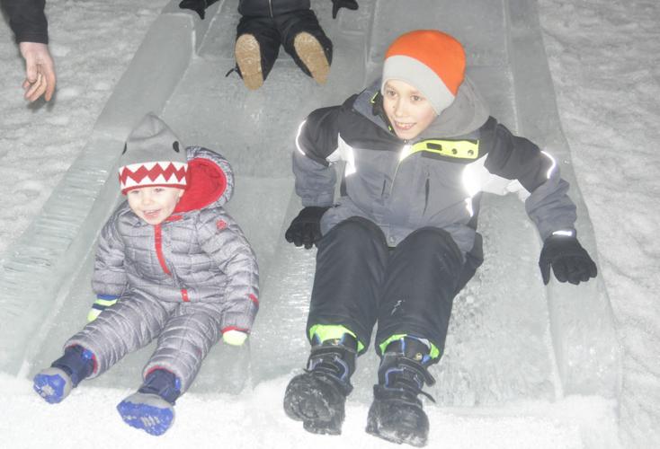 Brothers on slide at ice castle