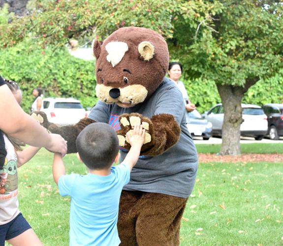 Bear and student high-five