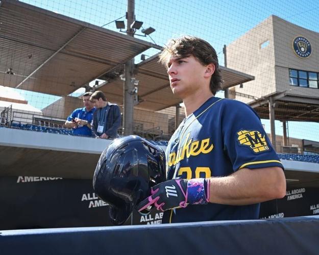 Milwaukee Brewers infield prospect Josh Adamczewski walks along the dugout during spring training workouts Tuesday, February 17, 2026, at American Family Fields of Phoenix in Phoenix, Arizona.