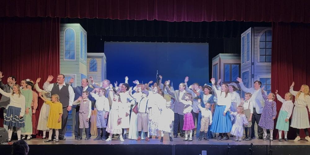 The cast of "The Music Man" welcomes the "Wells Fargo Wagon" into town