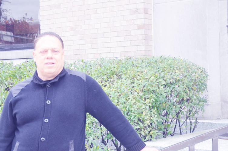 Ken Dillingham stands outside the Lake Geneva post office, where recently retired