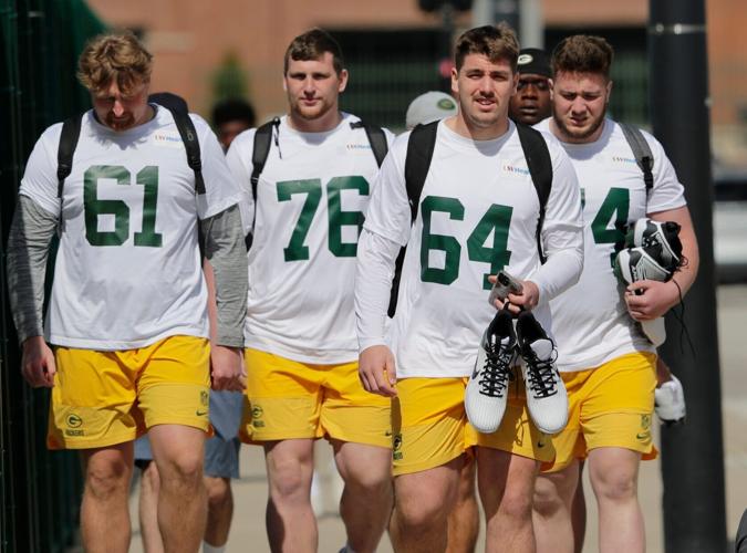Green Bay Packers Karsen Barnhart (61), Josh Gesky (76), Dain Walter (64), and Dylan Barrett (74) arrive during rookie minicamp