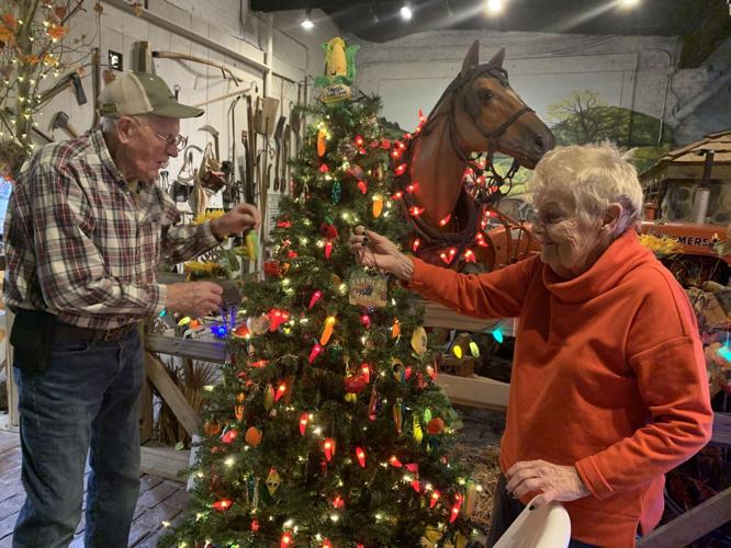 Robert and Mary Ann Pearce, co-owners of Pearce's Farm Stand, decorate their tree