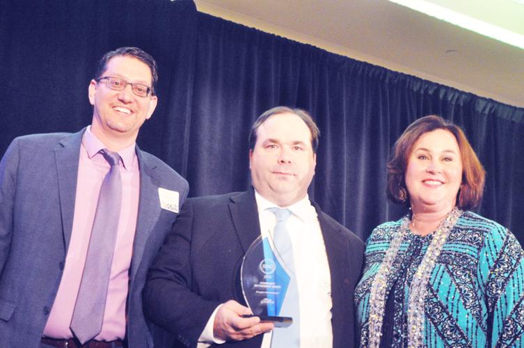 Dan Kostzeski, general manager for Emagine Lake Geneva, accepts the community betterment