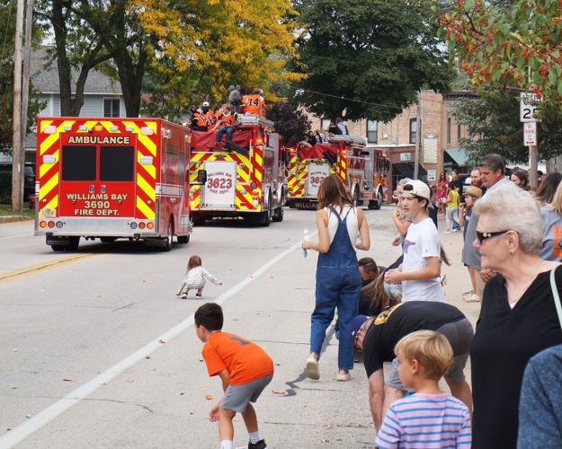 A large crowd lines West Geneva Street for the 2023 Williams Bay High Schiool homecoming parade