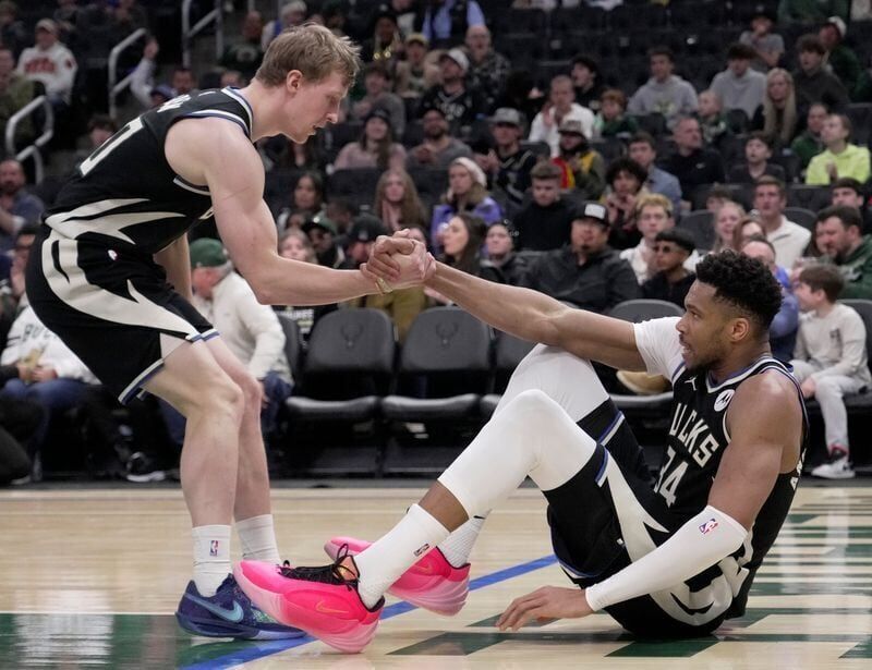 Milwaukee Bucks guard AJ Green (20) helps forward Giannis Antetokounmpo (34) to his feet during the first half of their game against the Indiana Pacers Sunday, March 15, 2026 at Fiserv Forum in Milwaukee, Wisconsin.