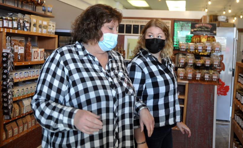 Roberta Robers, co-owner of The Farmstand, and her daughter, Danielle Robers, prepare to stock some shelves