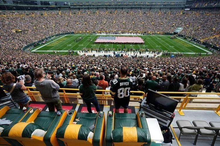 Green Bay Packers fans stand for the National Anthem
