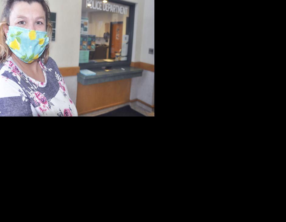 Voter wearing protective mask waits in line to vote