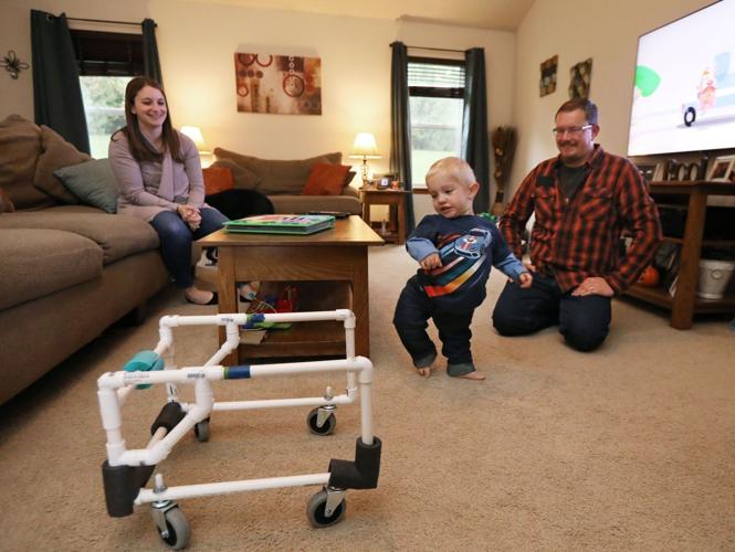 Theo with walker and parents