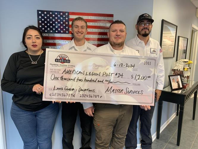 Master Services employees prepare to donate a $1,200 check to the Lake Geneva American Legion Post No. 24