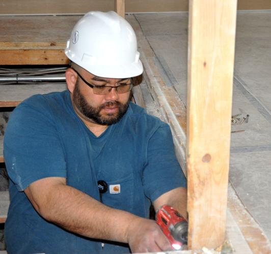 James Clendening, Nikao Group employee, does some drilling work as part of the Brick & Mortar renovation project