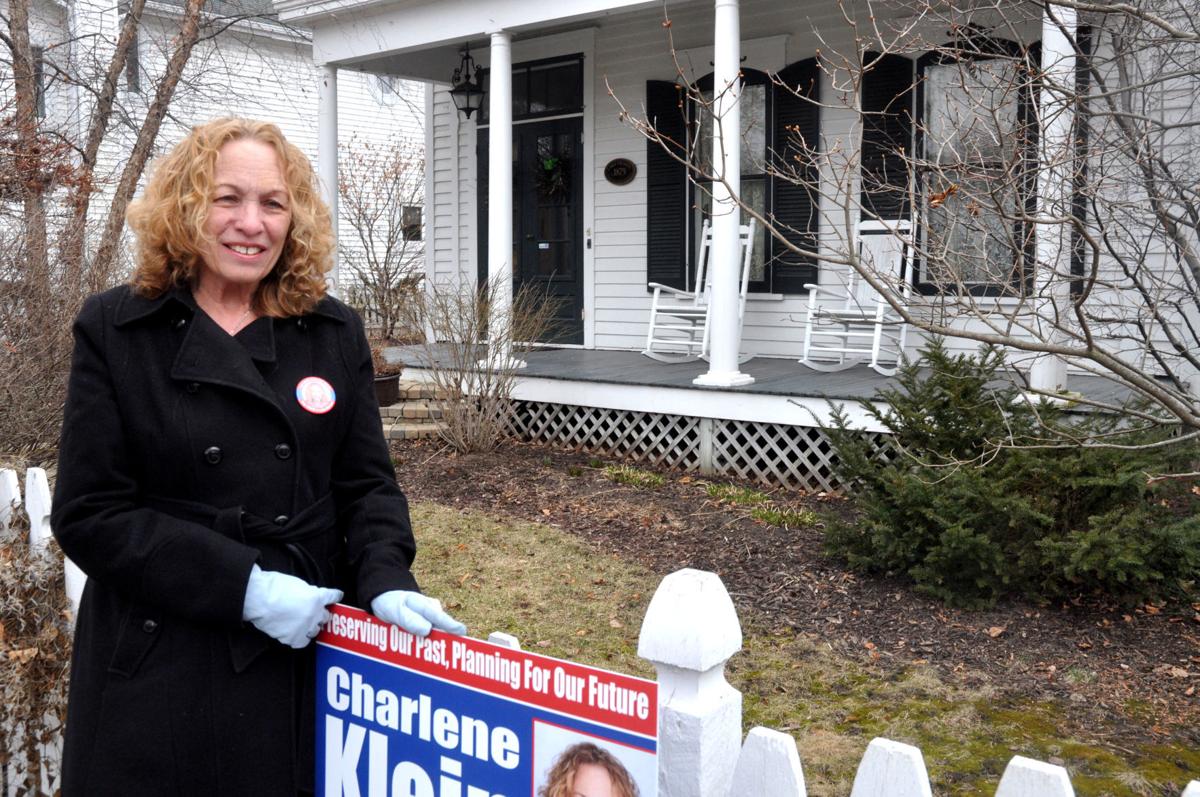 Mayoral candidate Charlene Klein stands next to one of her campaign signs