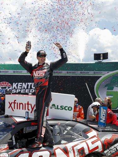 Xfinity Series driver driver Kyle Busch (18) celebrates after winning the XFINITY Series Alsco 300 auto race, Saturday, July 8,