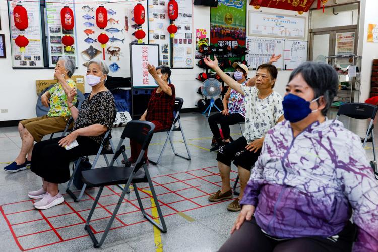 Senior citizens participate in an exercise workshop at a  community activity centre in Penghu