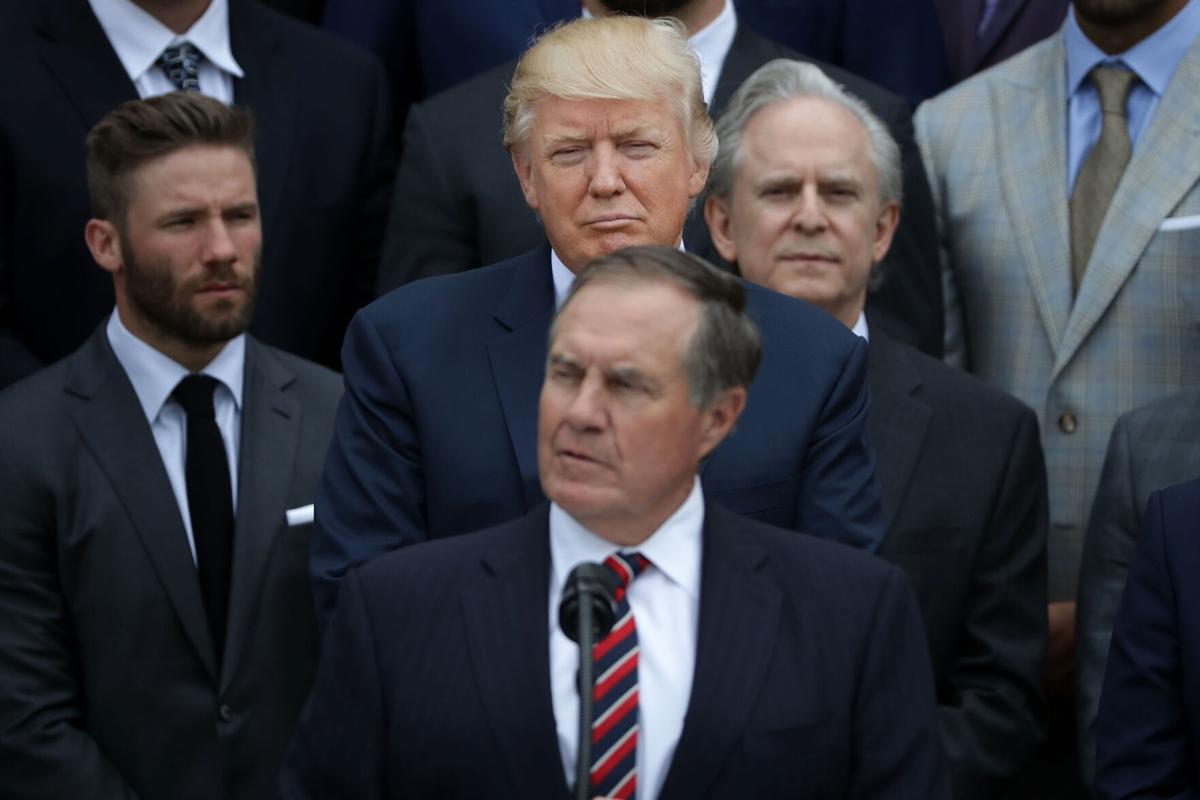 U.S. President Donald Trump, center, listens to New England Patriots Head Coach Bill Belichick deliver remarks during an event celebrating the team's Super Bowl win on the South Lawn at the White House April 19, 2017 in Washington, DC.
