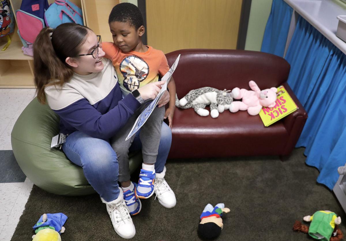 Teaching assistant Anna Muniz reads a book together during a Head Start preschool class in Wisconsin on Thursday, April 4, 2024.