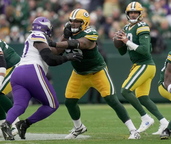 Green Bay Packers guard Aaron Banks (65) provides pass protection for quarterback Jordan Love (10) during the first quarter of
