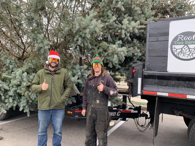 Jesse Snopek and Troy Smallz-Neault give a "thumbs up" after transporting the Christmas tree