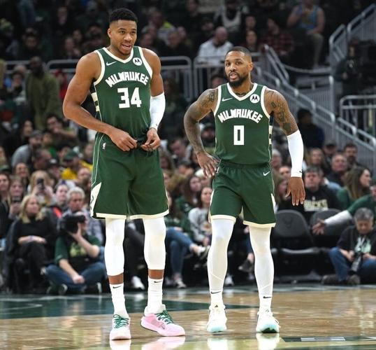 Milwaukee Bucks forward Giannis Antetokounmpo and guard Damian Lillard talk during a December 2023 game.