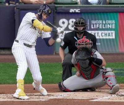 Milwaukee Brewers designated hitter Christian Yelich (22) hits an RBI single during the first inning of their game against the