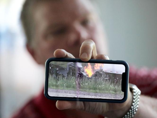 Ross with photo of burning truck