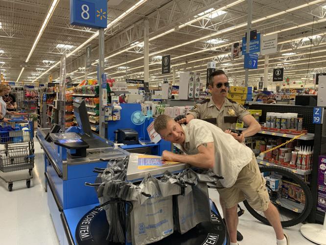 Thomas Lennon, as Jim Dangle, pretends to arrest a fan at Lake Geneva Walmart