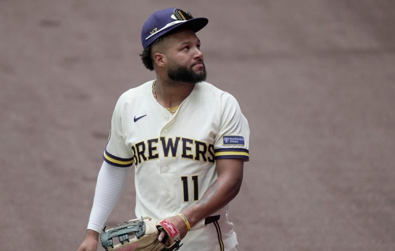 Milwaukee Brewers left fielder Jackson Chourio (11) looks back at the wall after being unable to field a home run hit by New