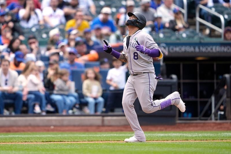 Colorado Rockies second baseman Orlando Arcia (8) reacts to hitting a home run as he rounds the bases against the New York Mets during the third inning at Citi Field on June 1, 2025.