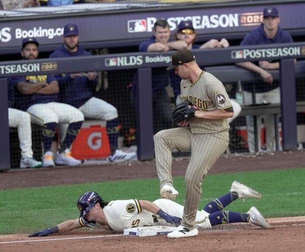 NLDS Game 1: Milwaukee Brewers right fielder Sal Frelick (10) is tagged out at first by San Diego Padres pitcher Michael King