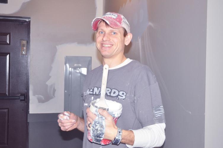 Dan Weyhrauch of Cal Johnson decorating prepares to some painting work