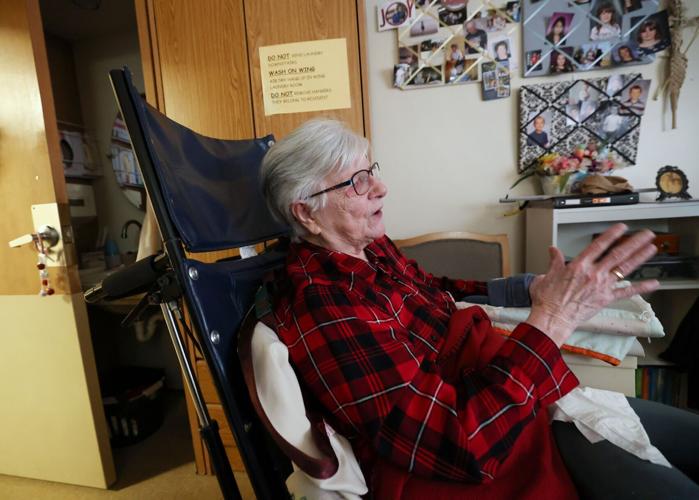 Grace with family photos in back