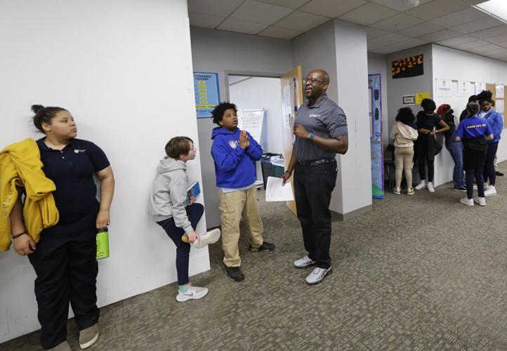 One City middle school principal Ayo Ogunniyi talks to students