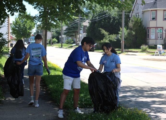 Youth Employment Program members clean up sidewalk