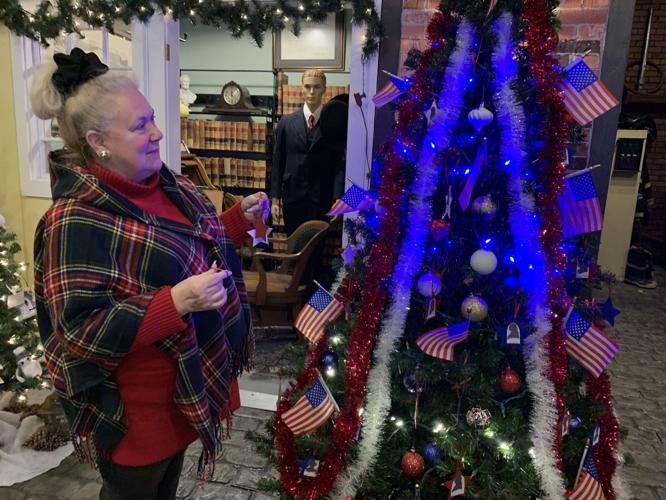 JaNelle Powers places ornaments on her team's Christmas tree