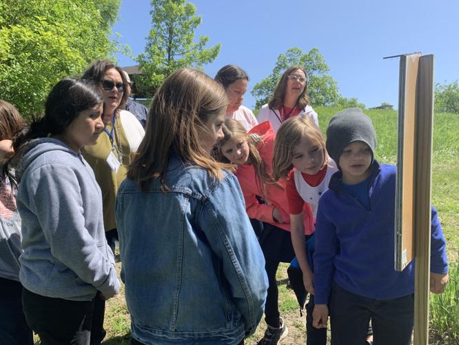 St. Francis de Sales students read the final post of the storybook trail