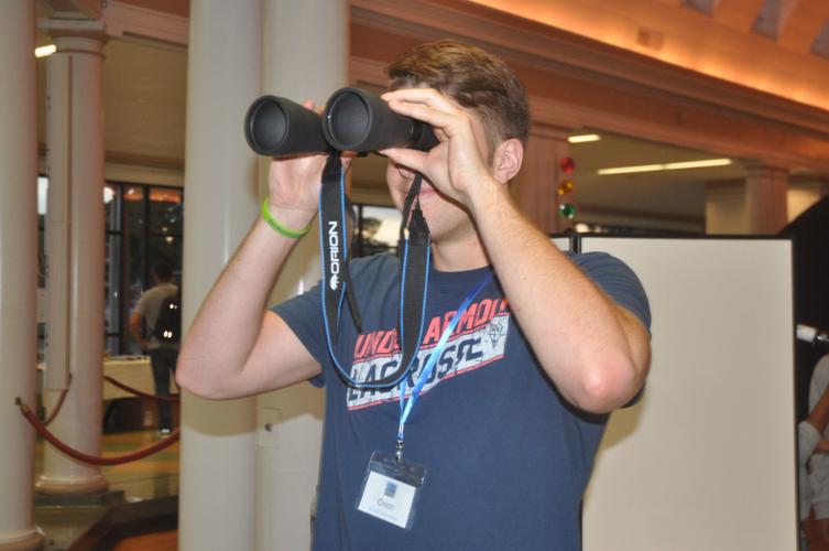 Orion Danou of Williams Bay looks at Geneva Lake through a pair of binoculars during the Star Party