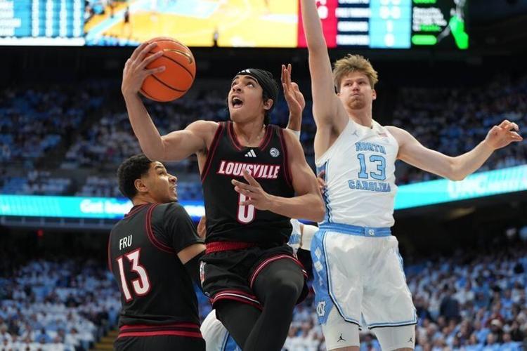 Feb 23, 2026; Chapel Hill, North Carolina, USA; Louisville Cardinals guard Mikel Brown Jr. (0) shoots as North Carolina Tar Heels center Henri Veesaar (13) defends in the first half at Dean E. Smith Center. Mandatory Credit: Bob Donnan-Imagn Images